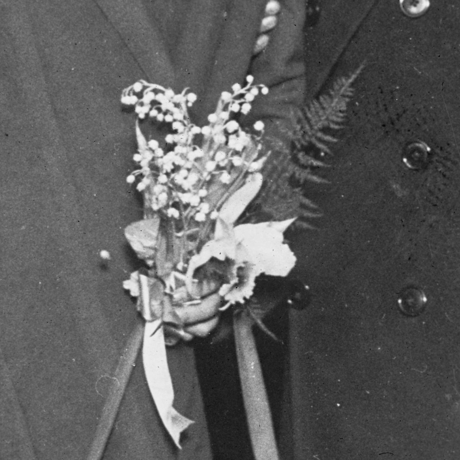 Front cover: a closeup of two clasped hands holding a bouquet of flowers